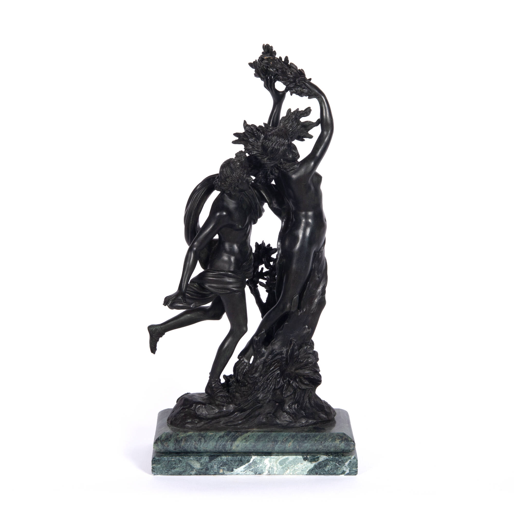 Bronze sculpture of a man, Apollo, behind a woman, Daphne, reaching up towards the sky.